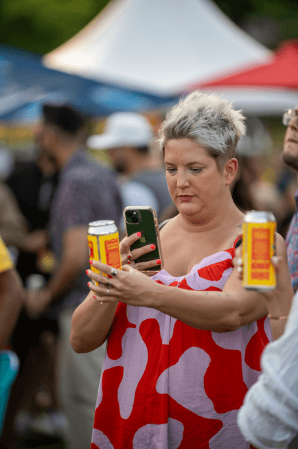 Person taking picture to can beer